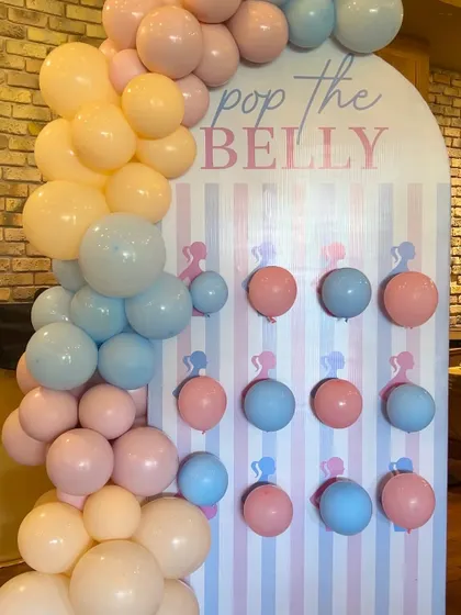 Fun and interactive games for guests, like this "Pop the Belly" balloon board, can be seamlessly integrated into the decor.