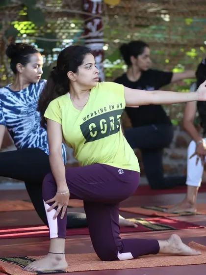 A focused participant holding a warrior pose during our retreat.