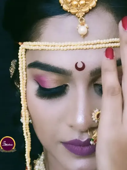 A close-up of a Maharashtrian bridal look, highlighting the dramatic eye makeup and traditional accessories.