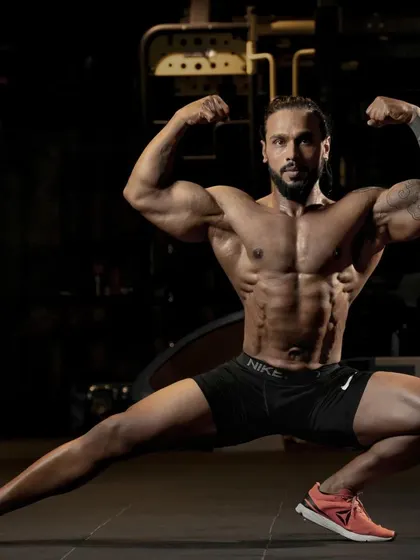 Holding a classic bodybuilding pose to display overall muscle development. This level of conditioning is achieved through a combination of intense training and a precise diet plan.