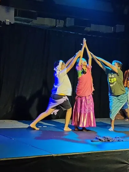 Children working together on stage, creating a human arch as part of their dynamic and energetic performance.