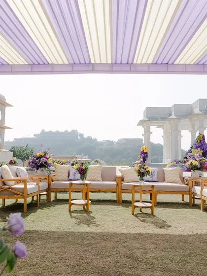 The lounge seating area for the Haldi, set up under a lavender and white striped canopy, offering guests a comfortable space to relax and enjoy the view.