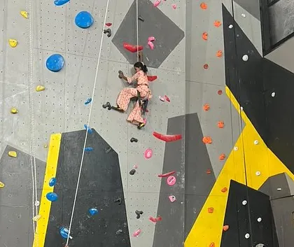 A young girl scales our top-rope wall during the community event. It was incredible to see the determination and happiness as these kids conquered new heights and discovered their own strength.