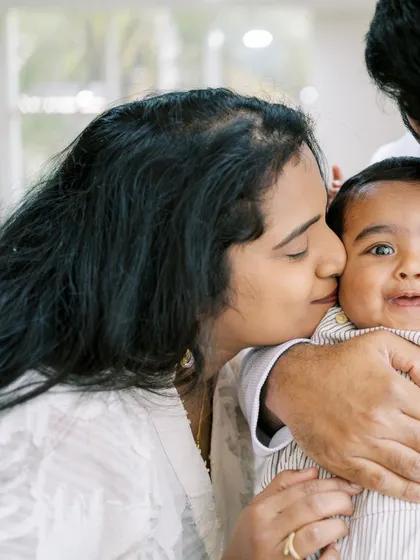 A mother kissing her baby's cheek. These close-up shots are perfect for capturing the sweet details and emotions.
