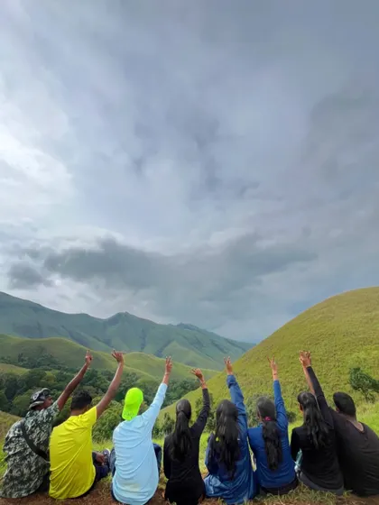 A group of friends enjoying the view from the top on our Kudremukha trek. It's all about making memories together.