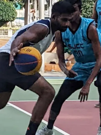 Dribbling against a defender in a 3x3 game.