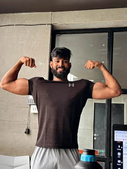A post-workout bicep flex, celebrating the pump and the hard work put in.