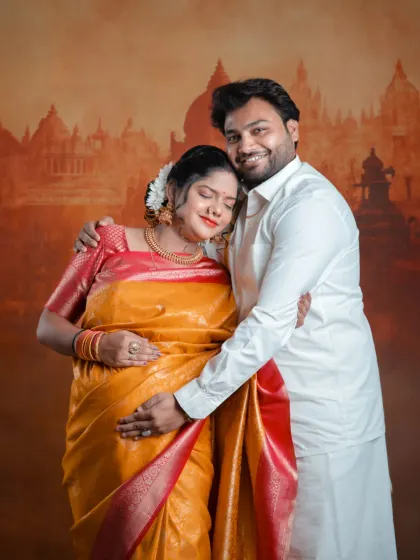 Resting in his arms, dreaming of holding the baby. This photo is a beautiful portrait of love, support, and anticipation, captured in our studio with a traditional theme.