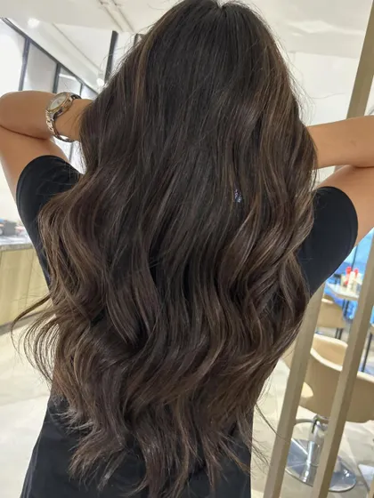 These subtle peek-a-boo highlights are perfect for adding a touch of dimension to long hair. I paired this three-tone color with a long layered haircut to enhance movement.