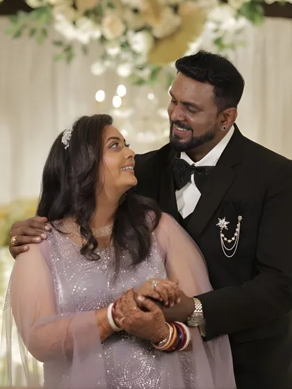 A happy couple at their event. Her makeup is glamorous and on point, with a soft smokey eye and glowing skin that looks beautiful in photos.
