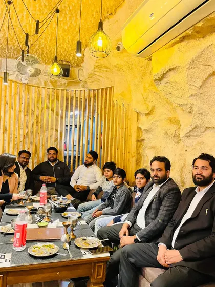 Celebrating a birthday with the team and family at a restaurant.