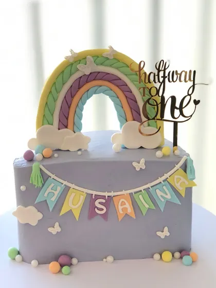 A lovely pastel rainbow cake celebrating "Halfway to One."