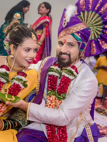 A playful moment between the bride and groom during their Maharashtrian wedding ceremony.
