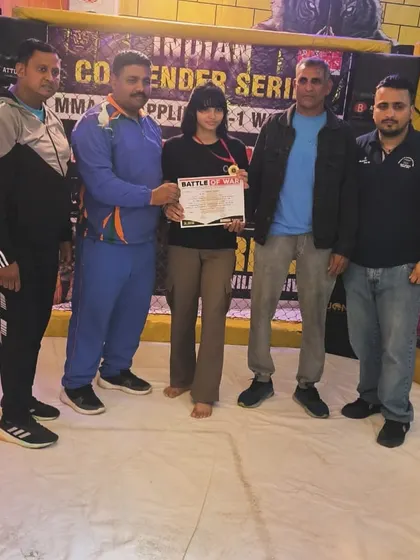 We don't just train, we build champions. Here is one of our athletes after winning a gold medal at the MMA Contender Series. The hard work in the gym pays off in the ring, and we are proud to coach fighters to victory.