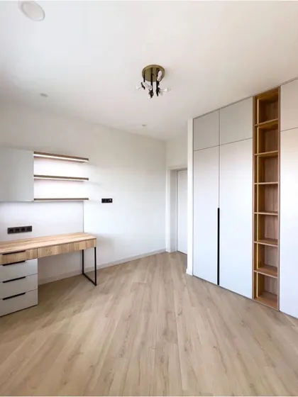 Another example of our integrated wardrobe and study desk solutions. This minimalist design is perfect for maximizing functionality in smaller rooms or for creating a cohesive look.
