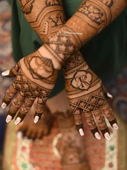 A clean and elegant design featuring the couple's initials, 'R' and 'K', set within geometric patterns for a modern bridal look.