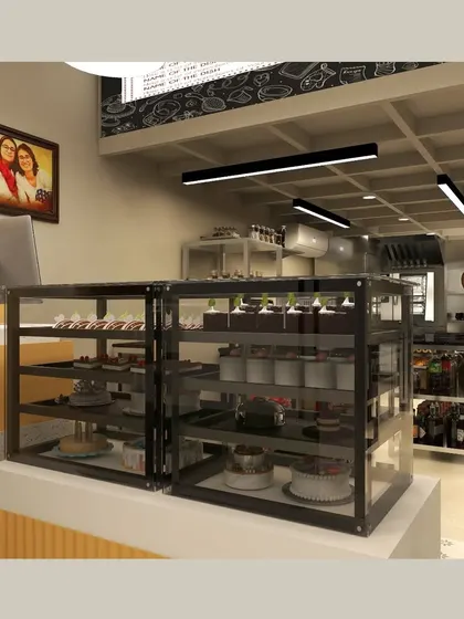 A look behind the counter at Ditya Bakehouse, showing the open-kitchen concept. This transparency builds trust with customers and integrates the baking process into the overall experience of the space.