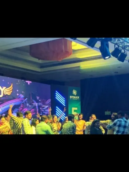 A shot from the Bitsilica anniversary party, with my logo on the screen and employees dancing.