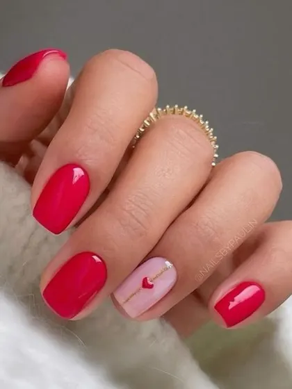 A simple and sweet Valentine's design. A single accent nail with a love letter heart complements the classic, glossy red of the other nails.