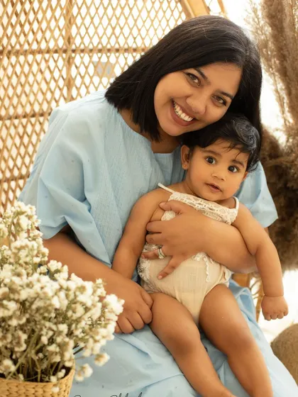 A close-up of the beautiful bond between a mother and her baby girl. Her smile says it all. These are the moments that become treasured family heirlooms.
