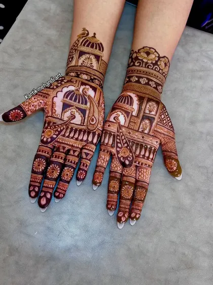 A beautiful trial mehandi design featuring peacocks and architectural motifs. This helps brides visualize how their final mehandi will look.