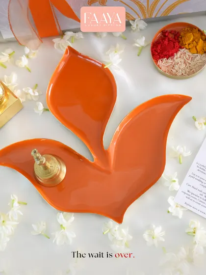 The wait is over. Our Pushpa tray, shaped like a blooming flower, is shown here as a puja thali, holding a small bell and kumkum, ready for a ritual.