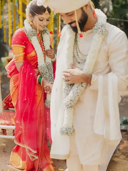 A shy, downward glance between the couple during their Marathi wedding ceremony.