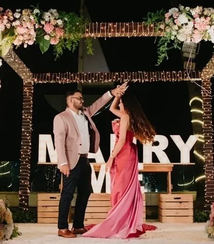 A dance to celebrate the 'yes'. The couple shares a joyful moment on the stage we created for their special proposal.