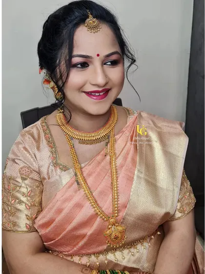 A beautiful close-up portrait of Shweta, highlighting the details of her baby shower makeup and her elegant updo.