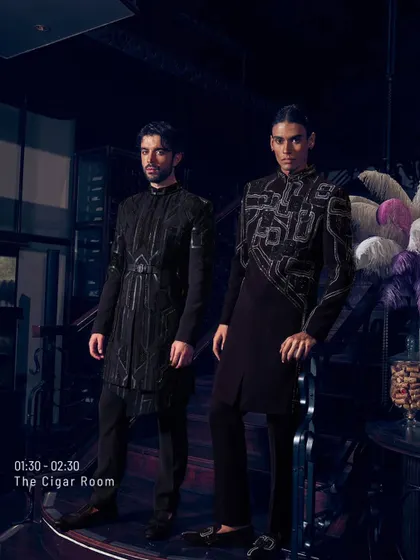 Here, two of my signature dark-hued ensembles stand in a space of quiet opulence. The architectural threadwork and asymmetrical cuts are designed to complement each other, showcasing the quiet extravagance that defines my work.