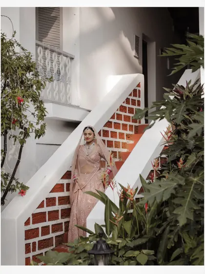 The bride descending the stairs at her Goa resort, a beautiful candid moment.