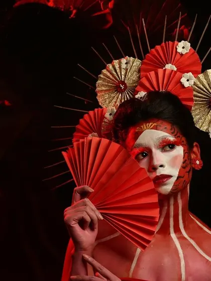 A full-body Geisha-inspired look. The red body paint and intricate headpiece showcase the level of detail and creativity involved in our fantasy makeup projects.
