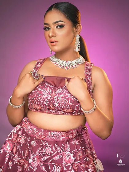 A confident and powerful pose, showcasing a full glam look that enhances the model's features beautifully.