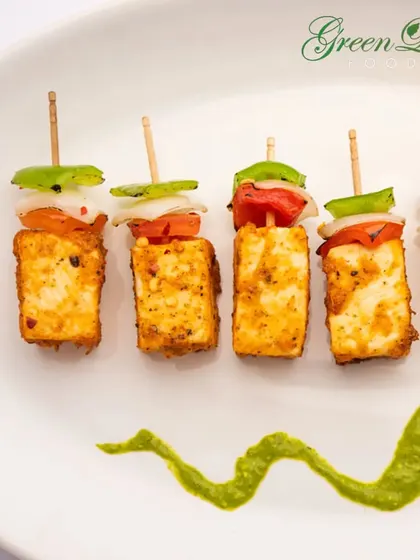 A vegetarian classic, our Paneer Tikka is marinated in flavorful spices and grilled to perfection. We serve it on skewers with chunks of onion and bell peppers, accompanied by a fresh mint chutney.