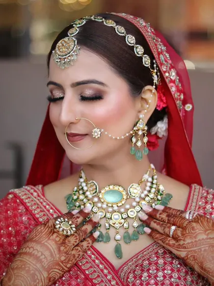 Another close-up with eyes closed, highlighting the flawless eye makeup and how it complements the tones in her jewelry.