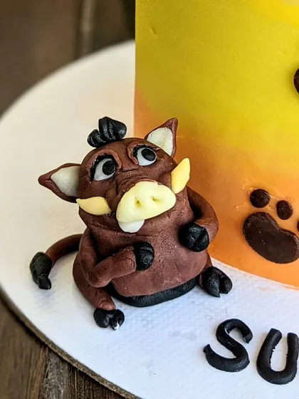 And of course, you can't have Timon and Simba without Pumbaa! This fondant Pumbaa topper captures his cheerful personality, completing the iconic trio for a memorable birthday cake.