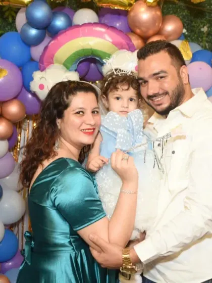 A lovely family portrait at a second birthday party. The colorful balloon arch and happy faces make this a perfect memory.