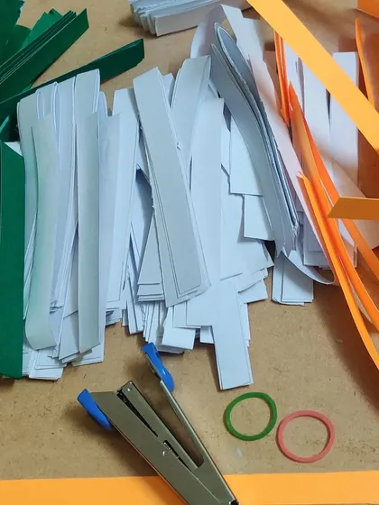The raw materials for our flag project: strips of colored paper, a stapler, and a lot of enthusiasm.