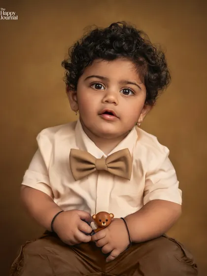 A dapper little gentleman! This baby boy with his adorable bow tie and teddy bear makes for a charming and classic studio portrait.