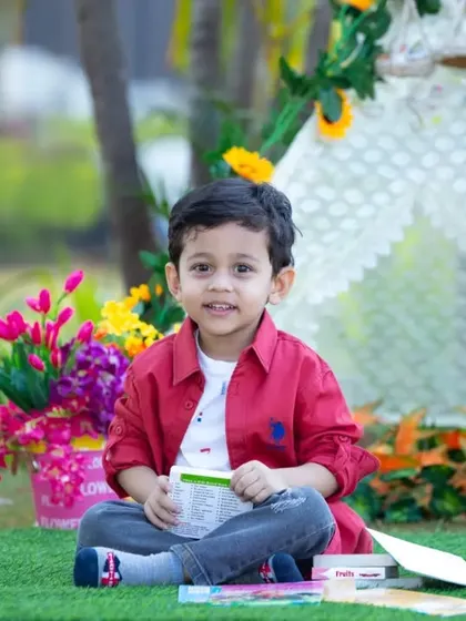A happy moment from a three-year-old's themed photoshoot. Our tent setups are versatile and can be customized with flowers and props to match your child's favorite colors and interests.