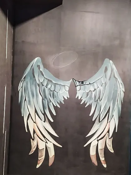 A work in progress shot of the angel wings. You can see how we build up the layers of color and detail to make the feathers look realistic.