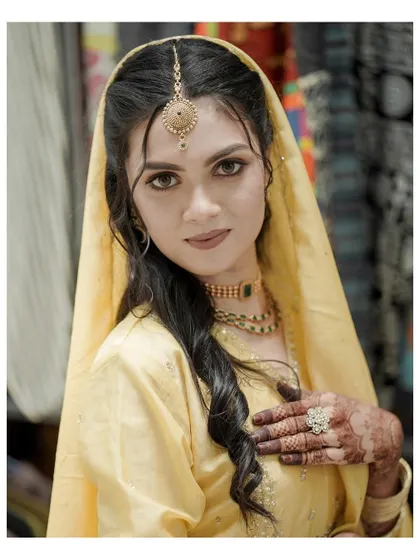 A classic close-up portrait of the bride, her direct gaze and beautiful traditional jewelry making for a powerful image.