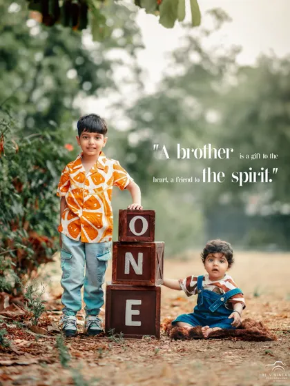 This outdoor sibling portrait celebrates a first birthday milestone. Using our wooden "ONE" blocks, we captured the sweet relationship between an older brother and his baby sibling in a beautiful, natural setting.