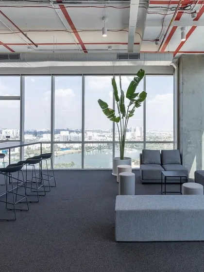 A breakout space at Netenrich overlooking the city, designed for relaxation and informal work. The use of natural light, simple furnishings, and indoor plants creates a calm and peaceful setting that provides a welcome contrast to the intensity of focused work.