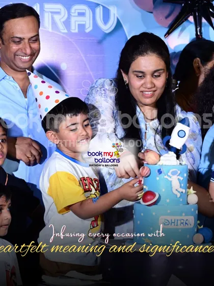 We infuse every occasion with heartfelt meaning. This photo captures a sweet moment of a family cutting a space-themed cake, showing how our decor creates the perfect backdrop for cherished memories.