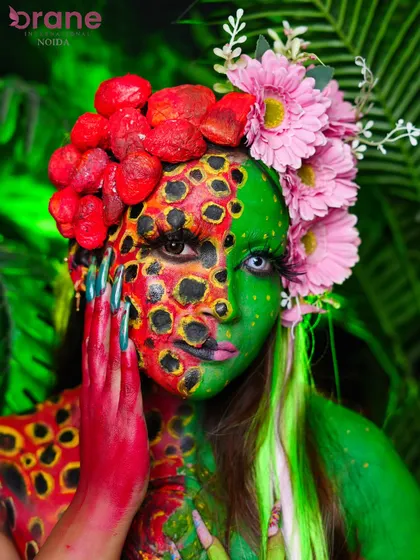 This pose highlights the hand and body paint, showing how the design flows from the face down to the body for a complete look.