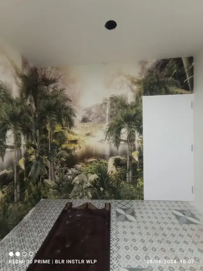 A misty jungle mural installed in a bedroom, creating a serene and mysterious atmosphere.