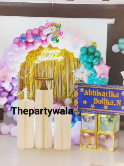 A unicorn-themed ring decoration with a gold shimmer backdrop, creating a magical and sparkly photo spot.