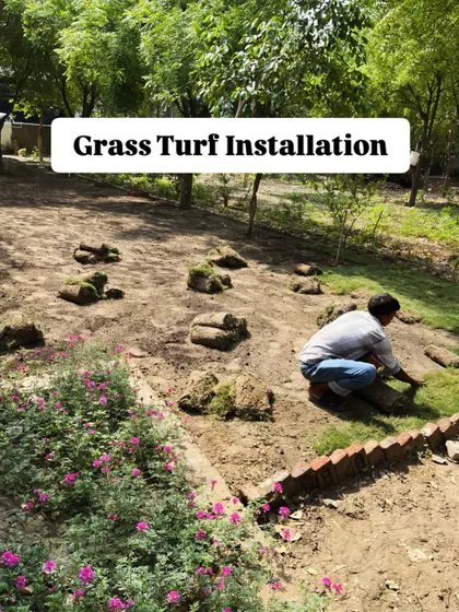 Our team member carefully lays down individual turf sections during the Noida lawn installation, ensuring a perfect fit and finish.