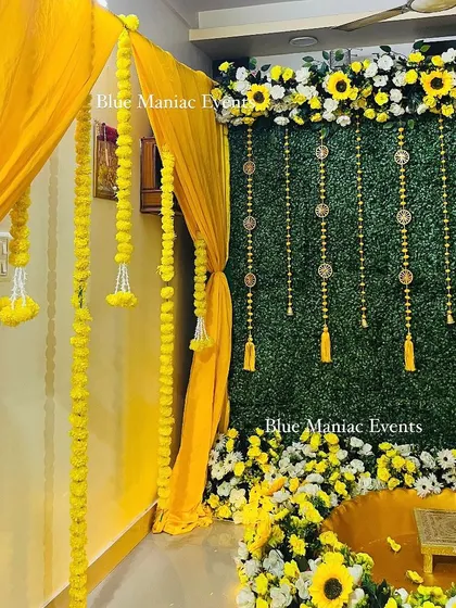 A side view of the grand Haldi setup, showing the entrance decorated with yellow drapes and marigold garlands.